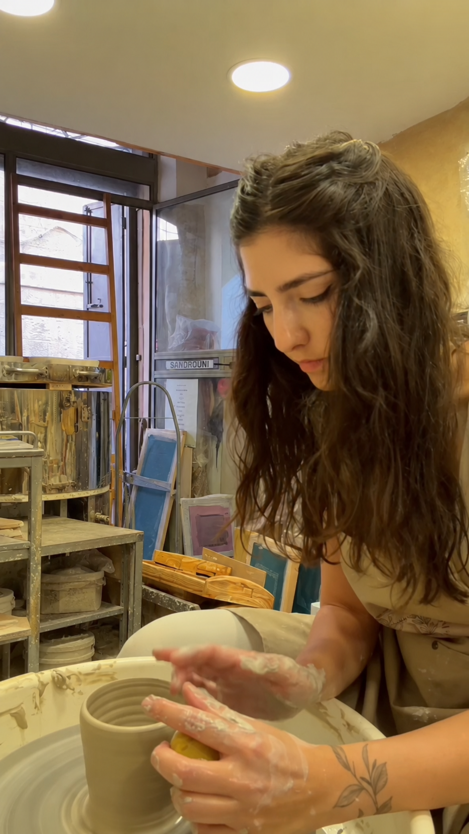 Jacqueline Sandrouni working at a pottery wheel