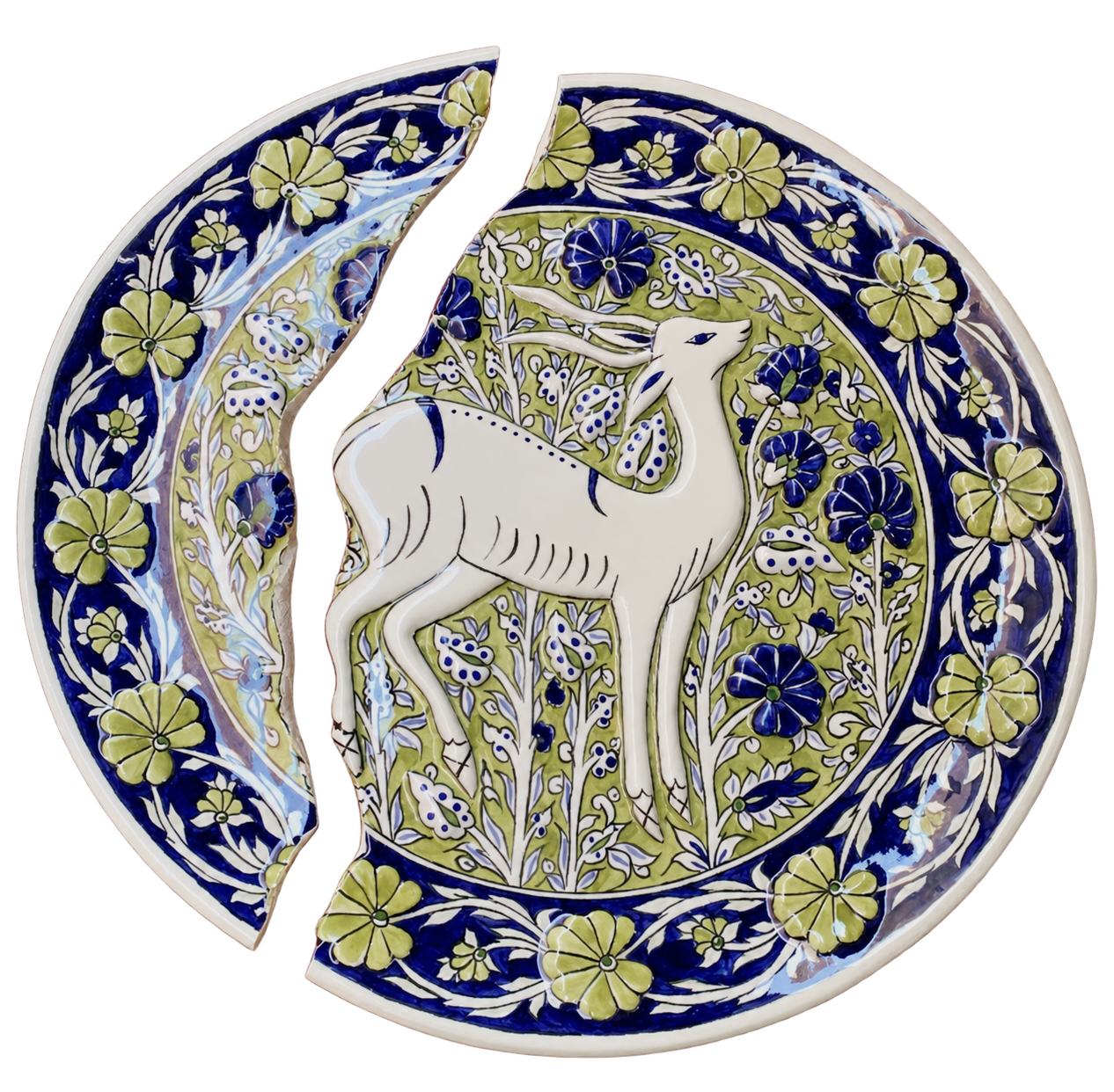 A recent broken three-dimensional ceramic plate with a raised deer and floral decoration, shown in two pieces.